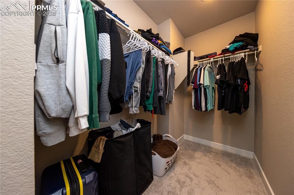 Image 26 of 32: Spacious closet with light colored carpet