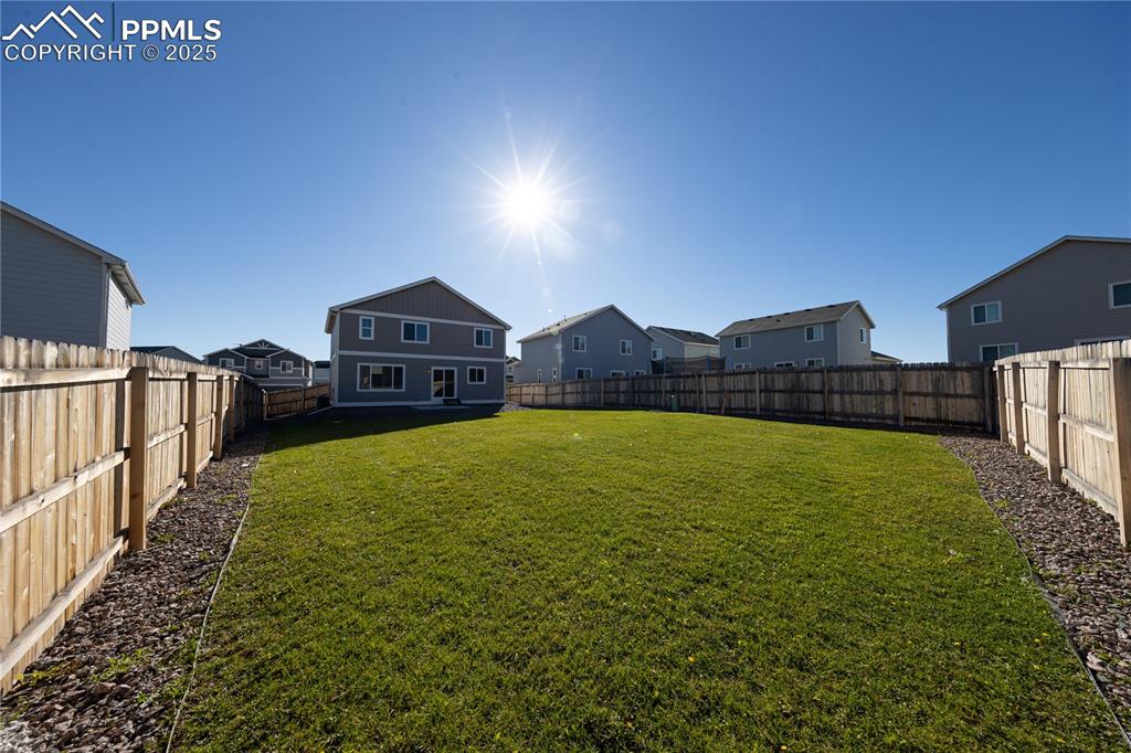 Image 29 of 32: Fenced backyard featuring a residential view
