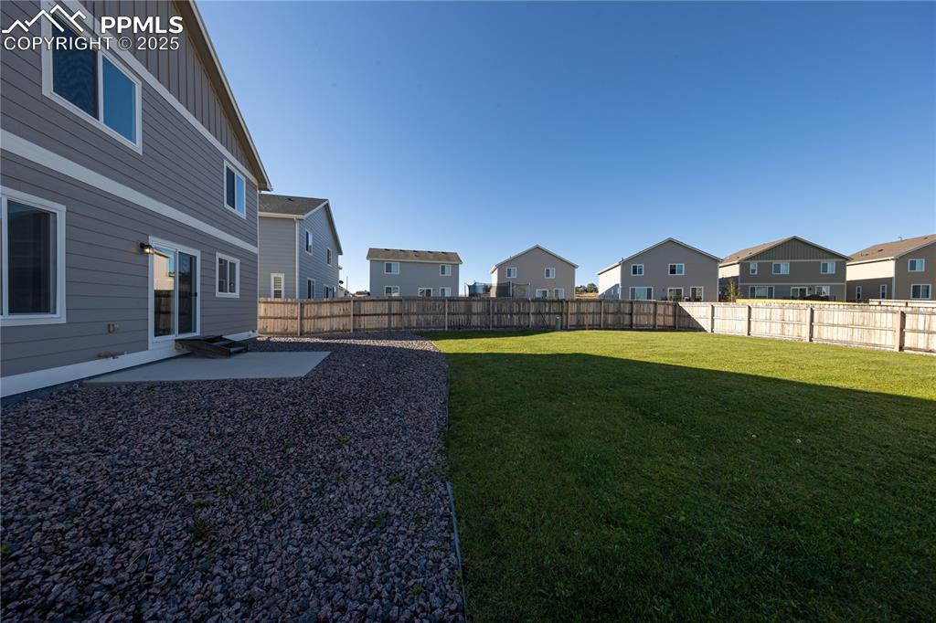 Image 31 of 32: Fenced backyard featuring a patio and a residential view