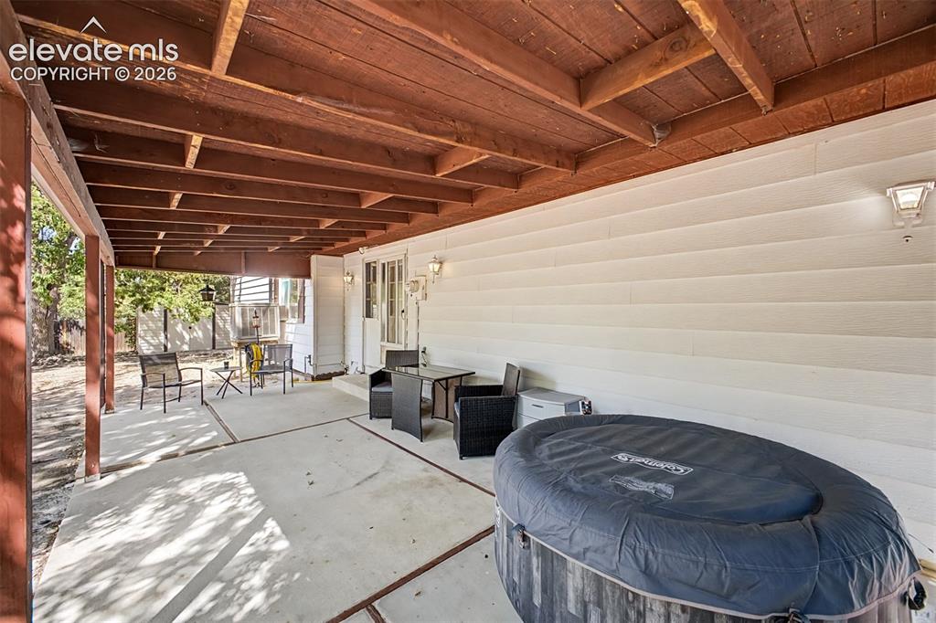 Image 13 of 44: Generous covered patio off the kitchen becomes extra living space to enjoy 