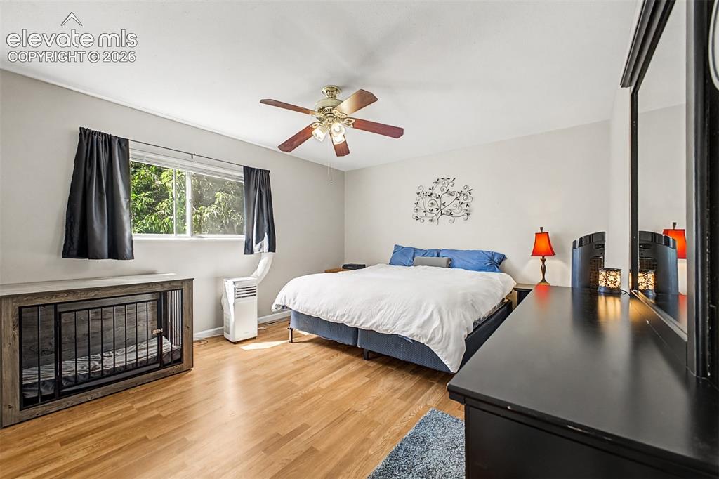 Image 14 of 44: Luxury vinyl tile flooring in the oversized primary bedroom featuring two s