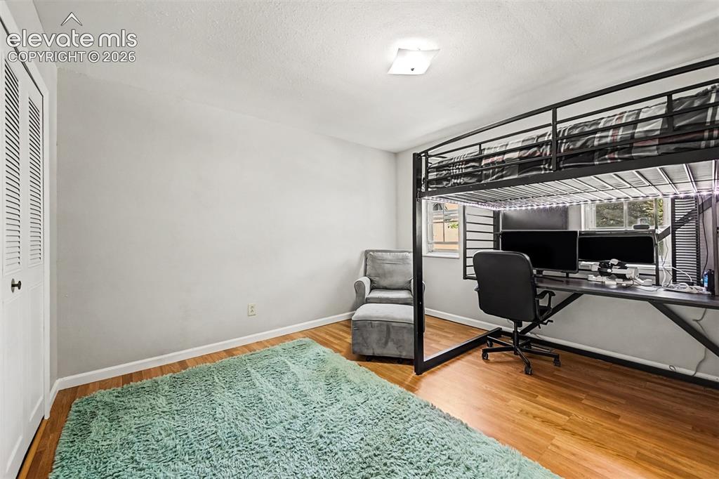 Image 17 of 44: Second upper level bedroom with two windows and LVP flooring also has extra