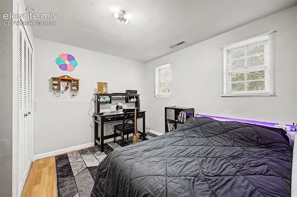 Image 22 of 44: Lower level third bedroom with garden level windows and ample closet space.