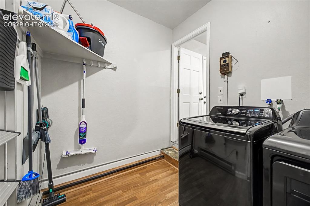 Image 24 of 44: Dedicated laundry area featuring luxury vinyl plank flooring and extra room
