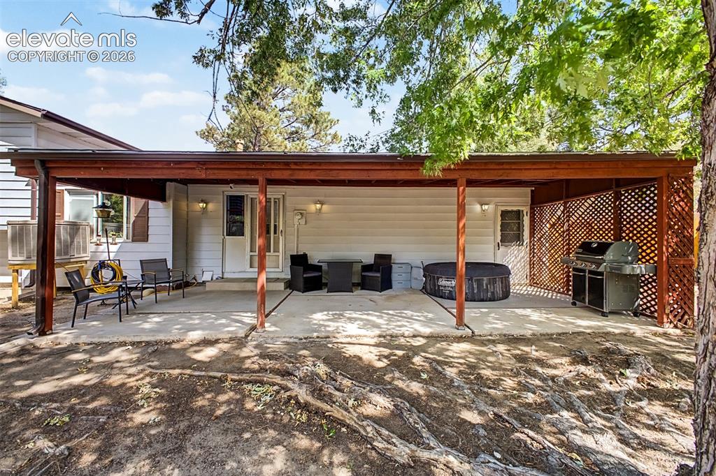 Image 25 of 44: Generous covered patio with a concrete flooring becomes extra living space 