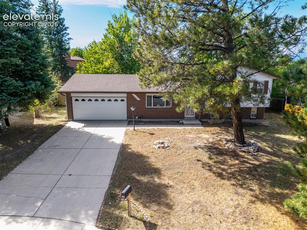 Image 29 of 44: Aerial photo of front exterior with 2-car garage and concrete driveway.