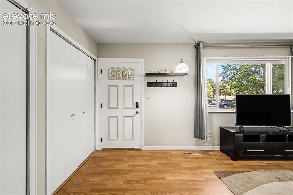 Image 5 of 44: Luxury vinyl flooring extends from the entry into the spacious living room 