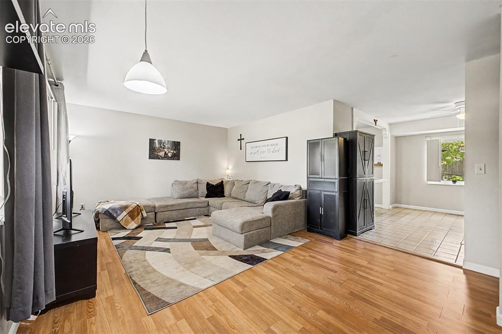 Image 6 of 44: Living room leads into the kitchen and dining area.
