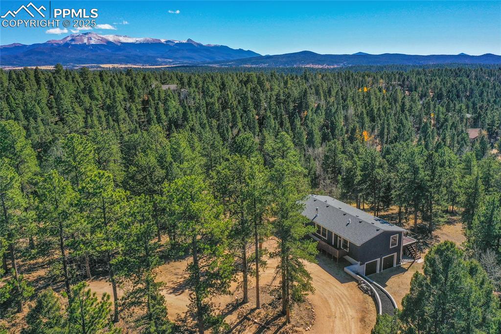 Image 16 of 47: View from above of property featuring a mountainous background