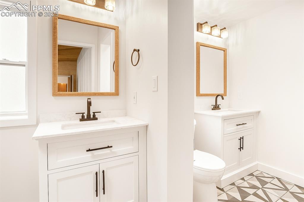 Image 27 of 47: Bathroom featuring two vanities and tile patterned floors