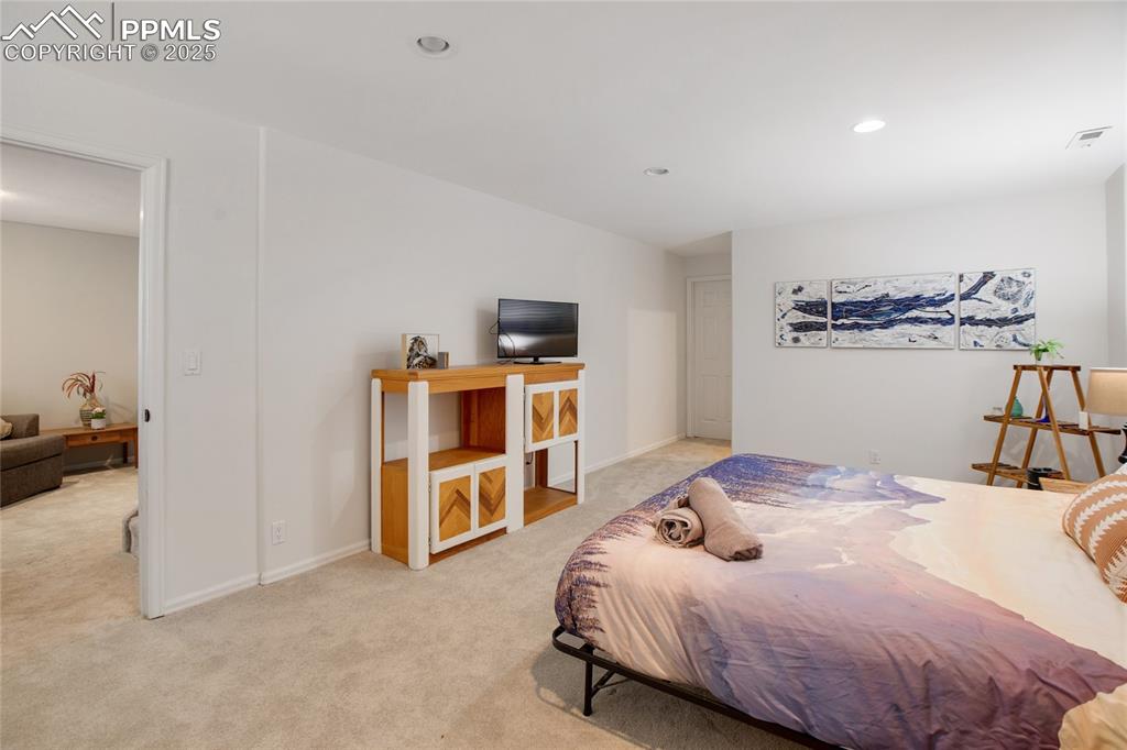 Image 38 of 47: Bedroom featuring light colored carpet and recessed lighting