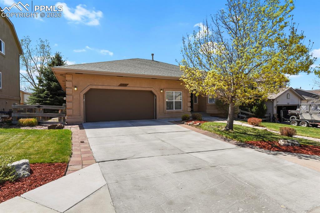 Image 2 of 45: Oversized 2 car garage with shelving and workbench