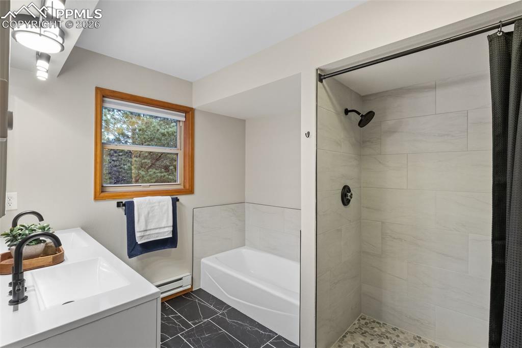 Image 18 of 40: Main Level Primary Bedroom with Ensuite 5 Piece Bathroom