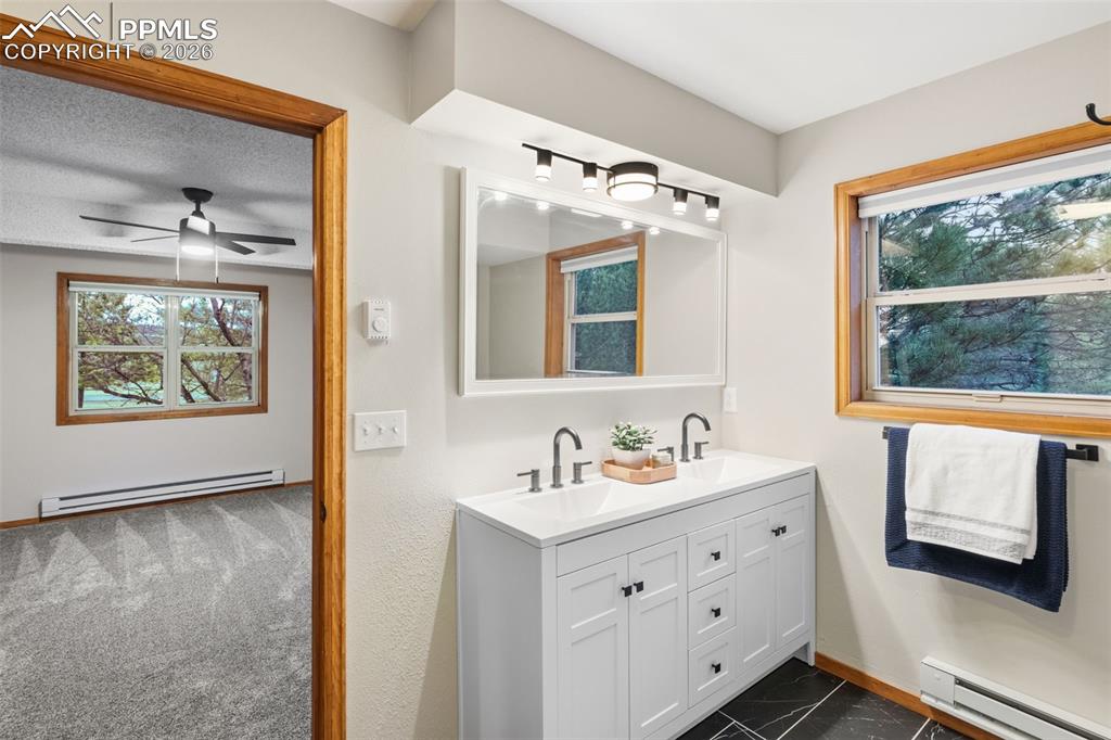 Image 19 of 40: Main Level Primary Bedroom with Ensuite 5 Piece Bathroom