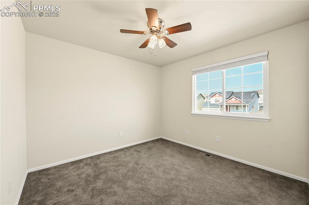 Image 18 of 28: Spare room with carpet floors and ceiling fan