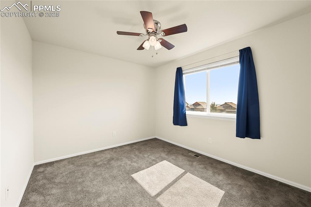 Image 23 of 28: Spare room with carpet flooring and ceiling fan