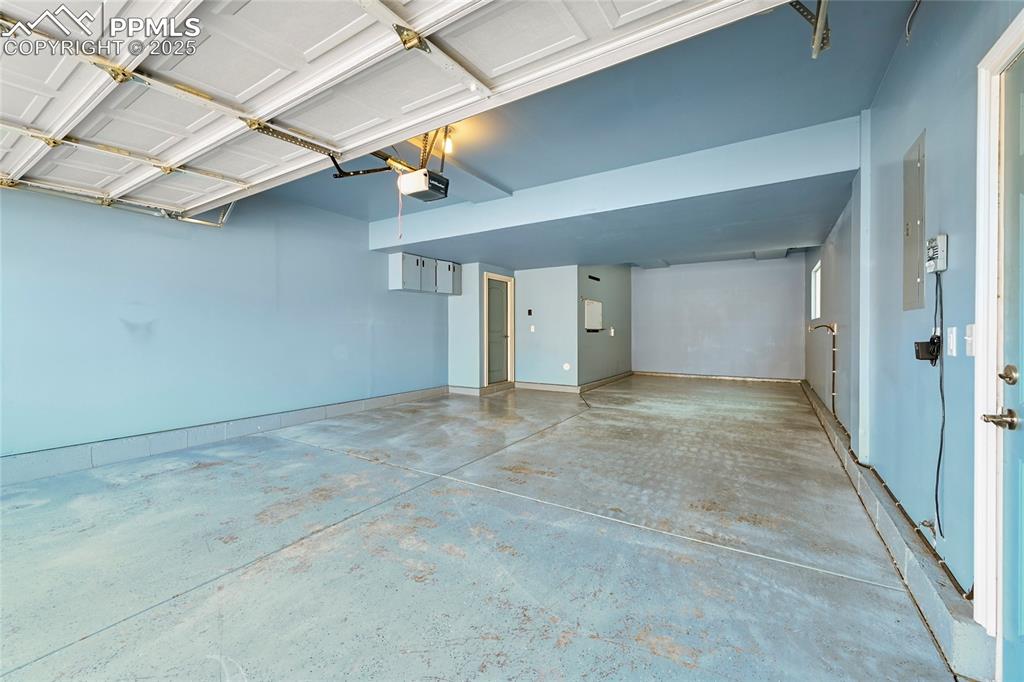 Image 26 of 28: Garage featuring a garage door opener