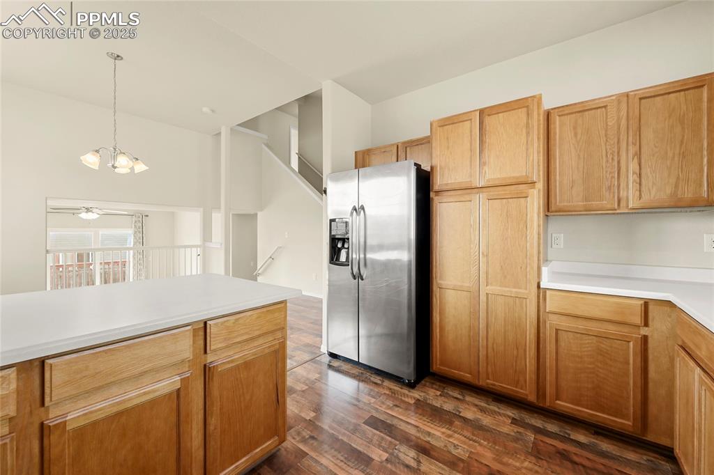 Image 8 of 28: Kitchen with stainless steel refrigerator with ice dispenser, light counter