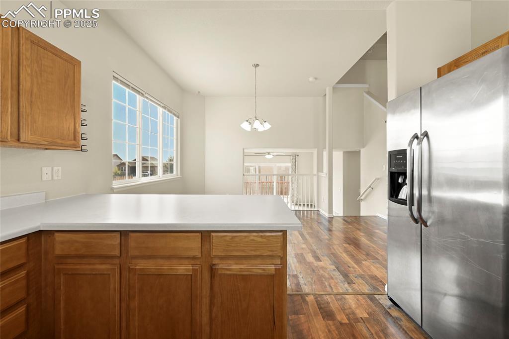 Image 9 of 28: Kitchen featuring stainless steel refrigerator with ice dispenser, brown ca