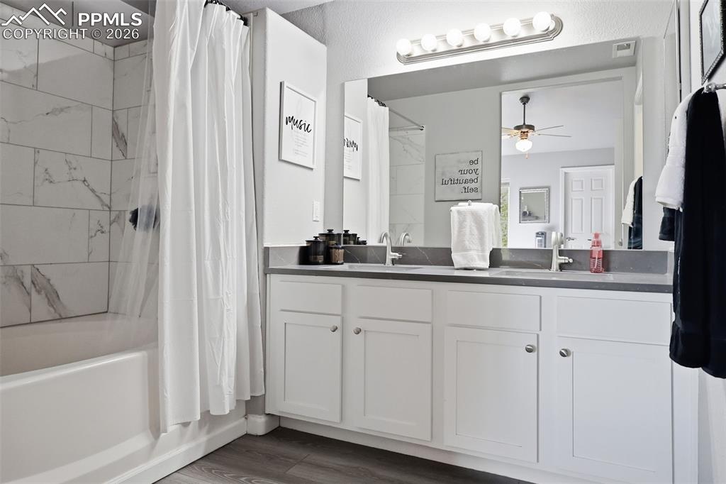 Image 23 of 32: Primary full bath with wood laminate