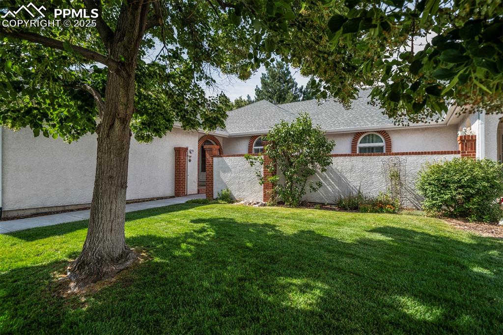 Image 2 of 40: Ranch-style house featuring stucco siding and roof with shingles