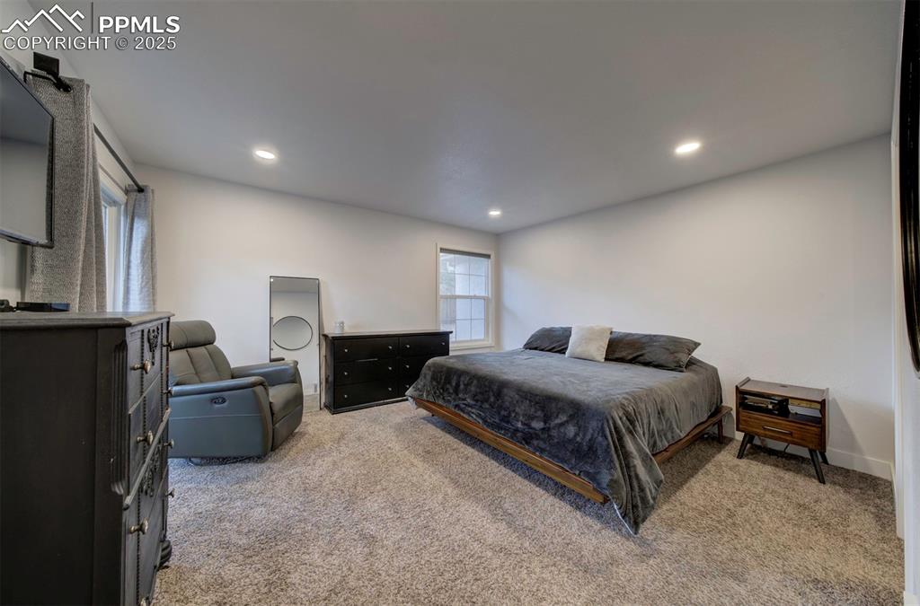 Image 28 of 40: Bedroom featuring light colored carpet and recessed lighting