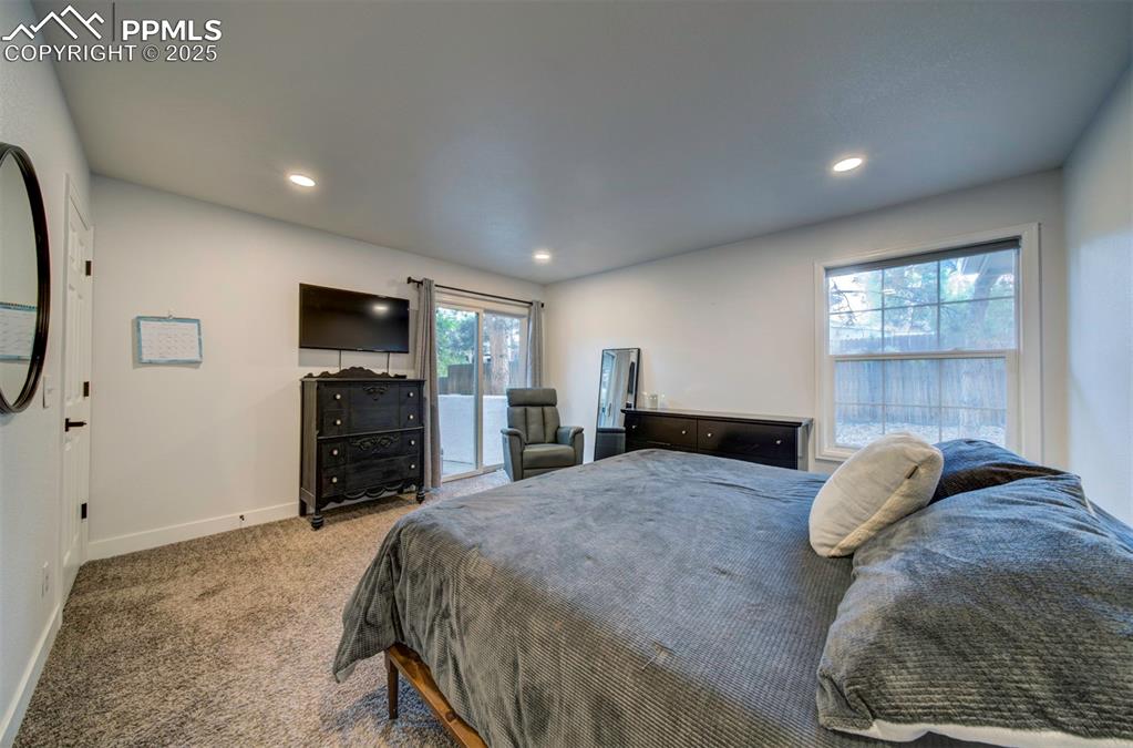 Image 29 of 40: Carpeted bedroom with access to exterior and recessed lighting