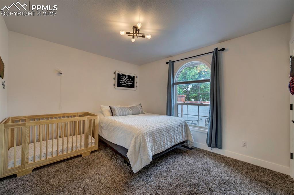 Image 36 of 40: Bedroom featuring carpet and baseboards