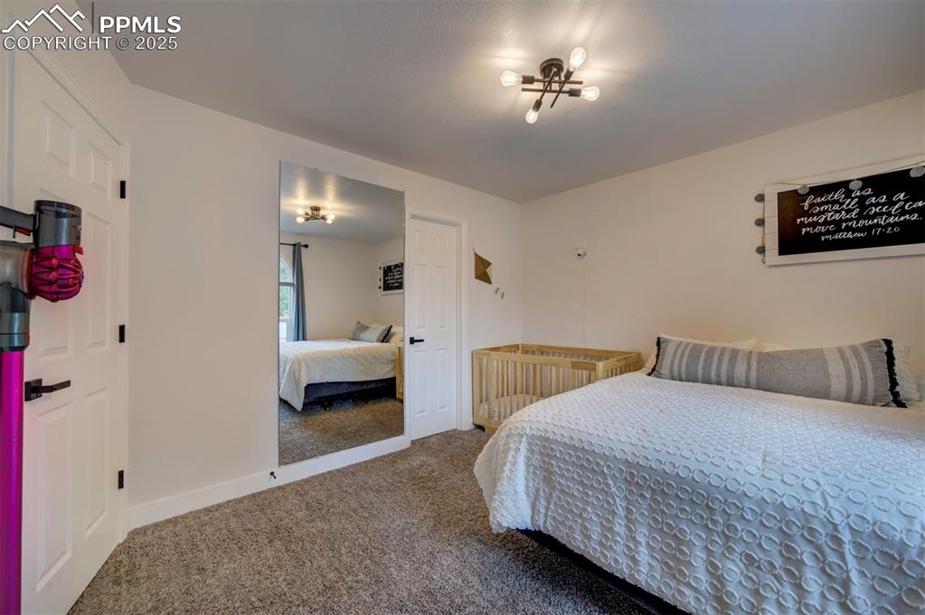 Image 37 of 40: Bedroom with carpet flooring and baseboards
