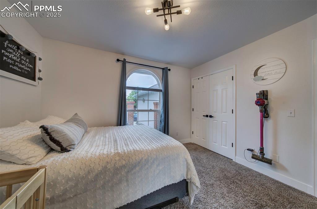 Image 38 of 40: Carpeted bedroom with baseboards and a closet