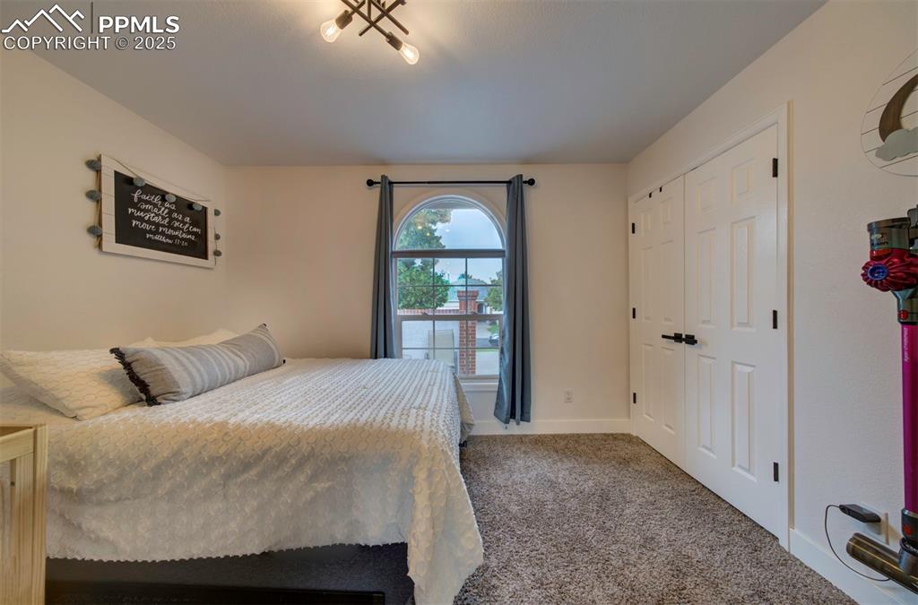 Image 39 of 40: Bedroom with carpet flooring and baseboards