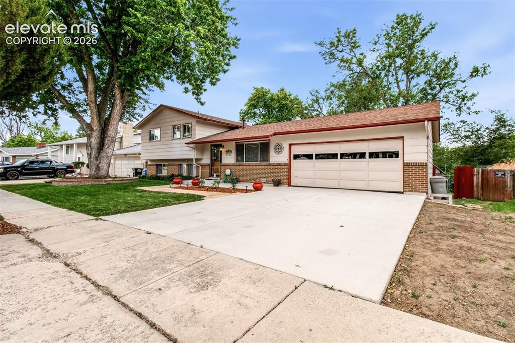 Image 23 of 30: Newer Roof, Nicely Landscaped, Newer Driveway, Attached 2-Car Garage