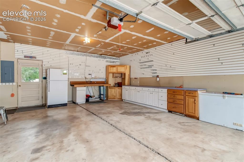 Image 24 of 30: Oversized Garage With Lots Of Storage
