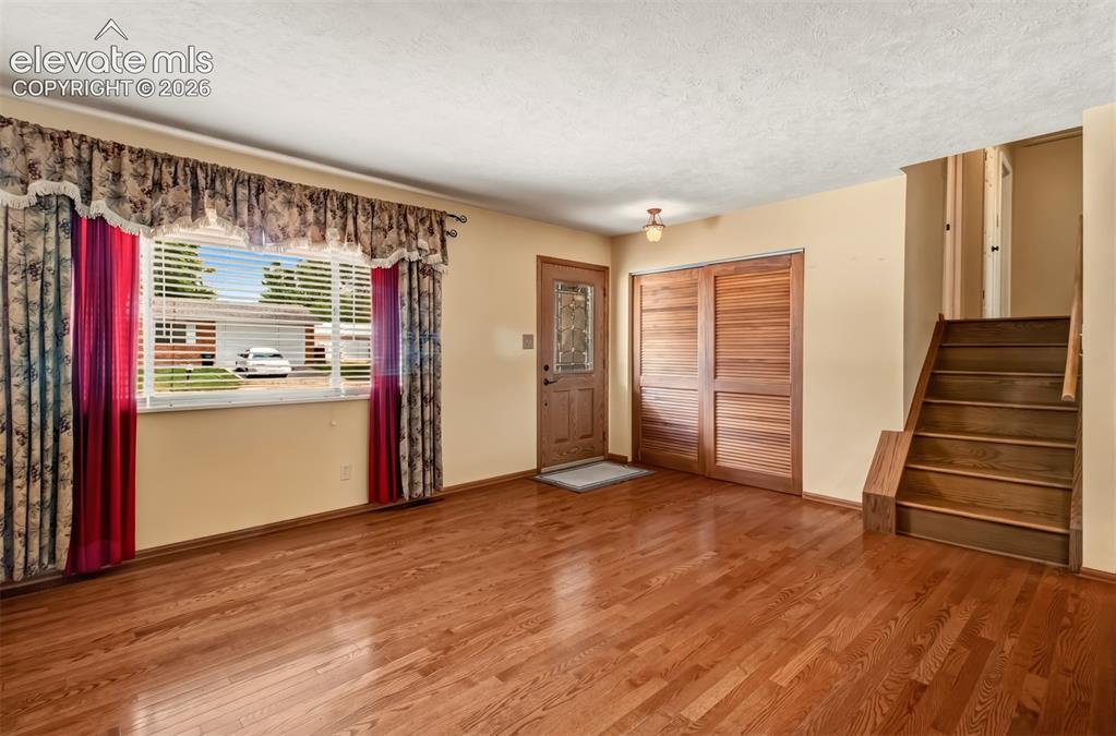 Image 8 of 30: Front Entry Into The Living Room Featuring Gleaming Hardwood Floors Into Th
