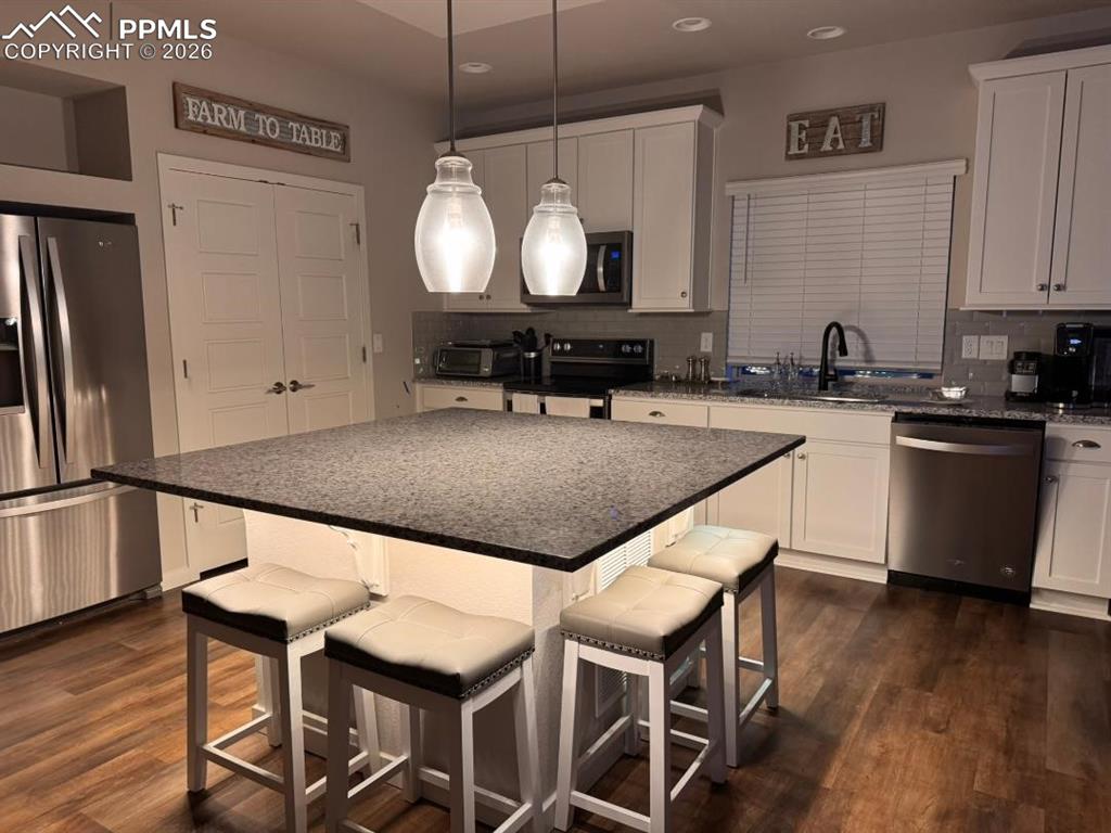 Image 3 of 42: Kitchen with Large Island, Granite Counters and Stainless Appliances