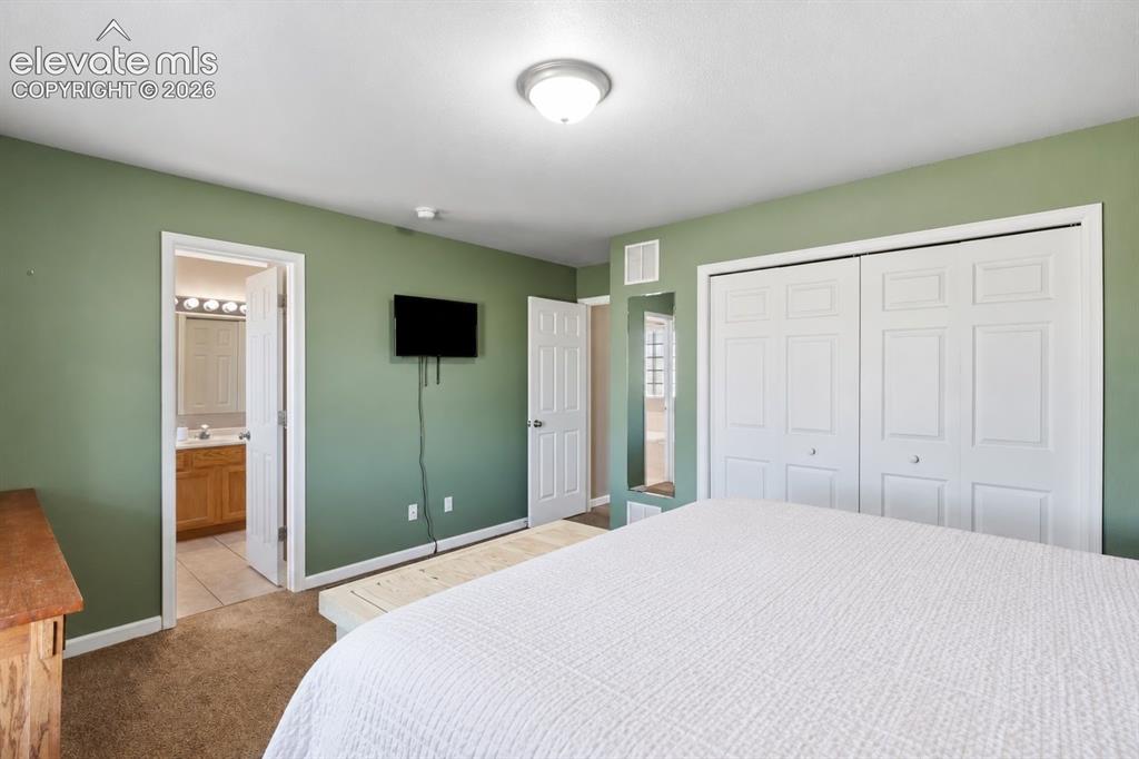Image 14 of 24: Primary bedroom with full ensuite bathroom.