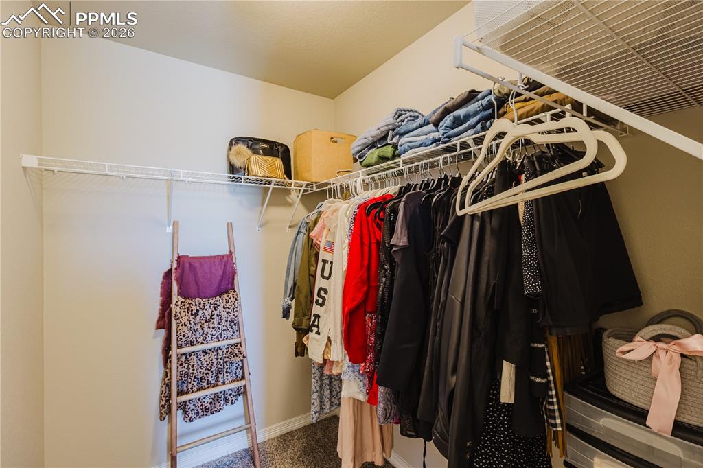 Image 32 of 39: primary bedroom walk in closet