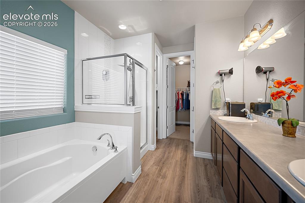 Image 22 of 49: Ensuite with double vanity, soaking tub, free standing shower and walk-in c