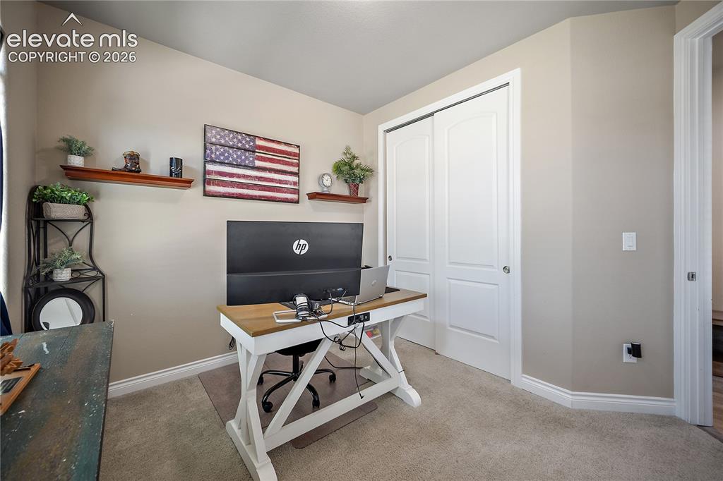 Image 5 of 49: Main level guest bedroom. Currently used as an office.