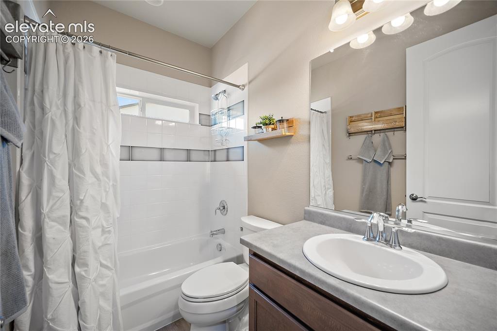 Image 6 of 49: Main level guest full bath.