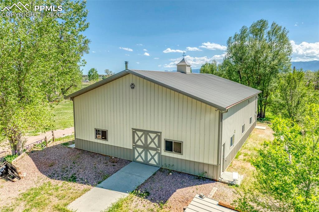 Image 15 of 27: The outbuilding is elevated above the flood plain and located on the west s