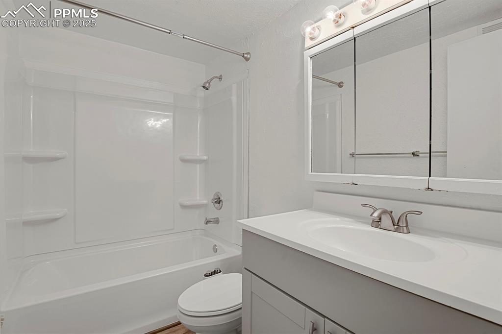 Image 11 of 17: Bathroom with shower / bath combination and vanity