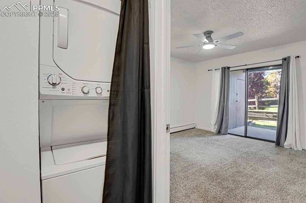 Image 12 of 17: Stacked washer and dryer located in the unit.