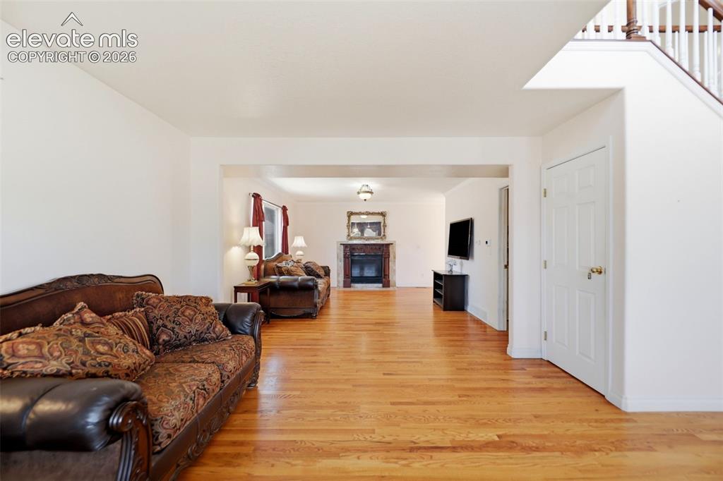 Image 13 of 50: Open concept living space featuring wood-finish flooring, white baseboards,