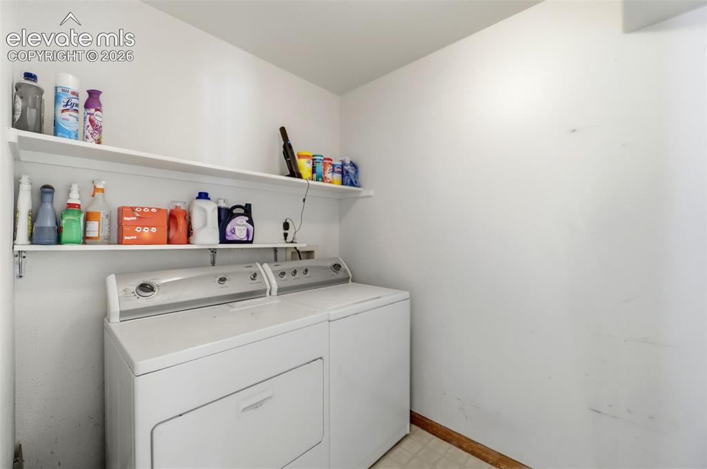 Image 14 of 50: Dedicated laundry area featuring white walls, two integrated white shelves,