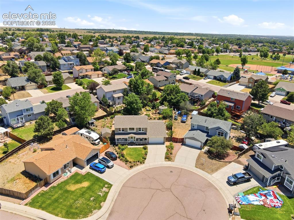 Image 47 of 50: Residential cul-de-sac featuring established homes with attached garages, p