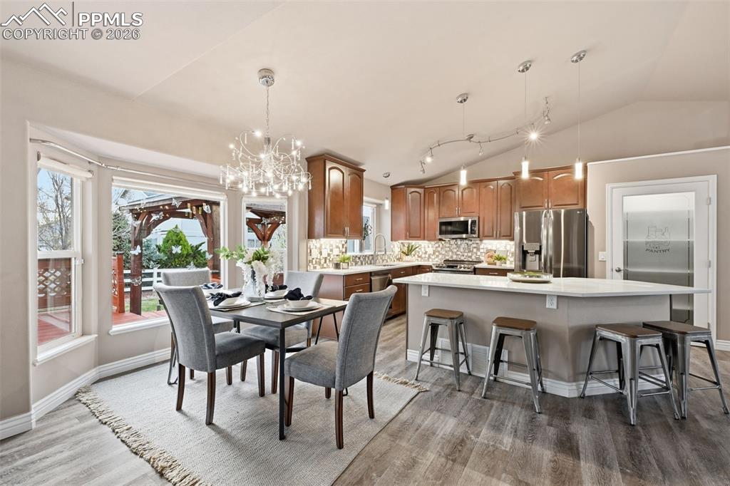 Image 16 of 50: Imagine entertaining your guests in this dining room. A unique chandelier w