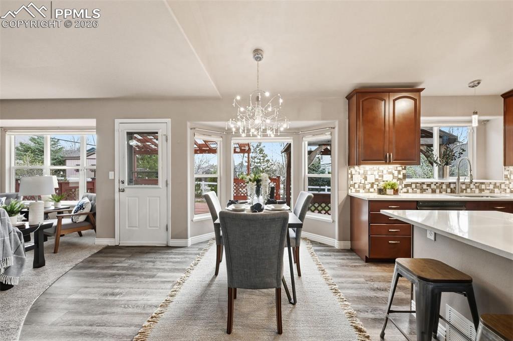 Image 17 of 50: The back door to the huge deck and delightful backyard for your summer adve