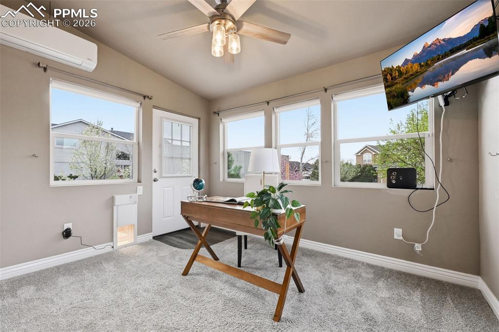 Image 19 of 50: The sun room with an door to the backyard. This room has a mini-split for t