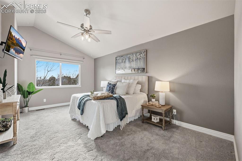 Image 22 of 50: Another view of the primary bedroom. The window has motorized black out sha